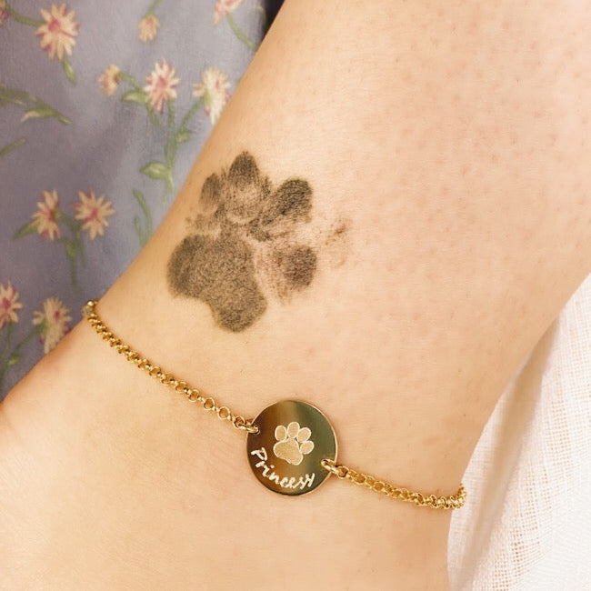 Perfect gift for any animal lover. The model is sporting our paw print anklet in gold filled with hand  script writing.