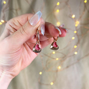 model holding Rose gold double hearts pendant hoop dangle earrings set on beige background. Heart charms, heart necklace, statement necklace, bohemian jewelry, boho jewelry