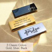 Three personalized money clips in classic finishes—black, gold, and silver—displayed on warm satin light. The black clip features engraved initials “EMB,” the gold clip shows typed text “The little bit of money left after my daughter’s wedding,” and the silver clip has a handwritten-style “best grandpa ever.” Custom metal money clip gift for him with text, monogram, or handwriting engraving; slim wallet alternative for Father’s Day, groomsmen, birthdays, or graduation by Danique Jewelry.