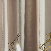 The camera pans down to show a silver and a gold family tree branch necklace. A person wears a gold necklace with a large alexandrite quartz stone and a small blue topaz and kyanite quartz. Each stone has a loose hanging engraved name tag. Two hands show off an up close shot of the necklace. Two hands open a red Danique Jewelry box revealing the branch necklace inside. This is the perfect Christmas, Mother's Day, birthday or anniversary gift for mom, grandma, or wife.