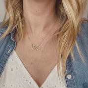 Video of model in white top wearing the gold filled square geometric necklace with kyanite and moonstone birthstones.