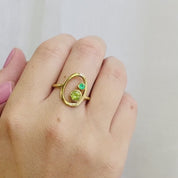 A person wears a single stone 3mm green onyx and a 5mm peridot open oval ring. This delicate egg shaped piece can be set with your choice of a mother and child's birthstone, with gemstone options for every month, plus alternative options if you want something a little different. Rings are available in gold, rose gold, or sterling silver and are hand crafted to your unique style. Birthstones available for January, February, March, April, May, June, July, August, September, October, November, December.