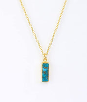 Vertical copper turquoise Adira bar necklace with gold filled cable chain with background. December Birthstone