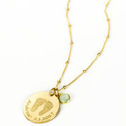 Gold filled necklace engraved with baby's footprints, name and date and add an optional birthstone charm to complete this perfect gift for mom on Mother's Day, for a push present, or birthday gift.
