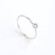 Sterling Silver Dainty December Birthstone Ring Blue Topaz Gemstone  on white background.