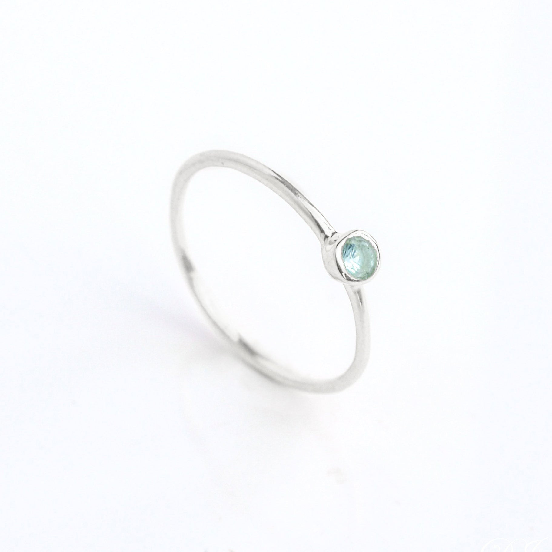 Sterling Silver Dainty December Birthstone Ring Blue Topaz Gemstone  on white background.