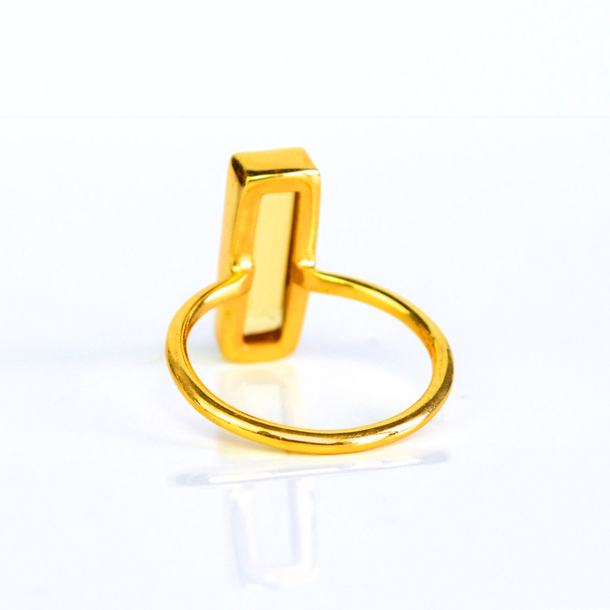 A citrine bar ring is facing away from the viewer to reveal an open back bezel setting. Citrine bar ring, gold silver rose gold, personalized handmade ring, November birthstone jewelry, birthday gift for sister, mother, best friend, Christmas gift, yellow crystal ring, positivity jewelry, custom citrine ring, unique gemstone accessory, thoughtful gift