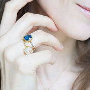 Model is stylishly stacking the kyanite pave cushion ring with white topaz and the moonstone cushion ring in gold plating. Stackable! Stacking rings.