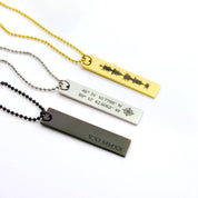 Collection of rectangle memorial tag necklaces in black with roman numerals, silver with a compass and coordinates or gold with a heartbeat engraved.