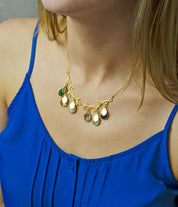 Model in blue top is wearing our branch necklace with prong set birthstone and engraved oval name tags.