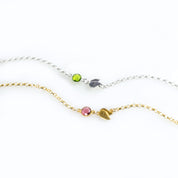 Single sterling silver double leaf initial charm with peridot birthstone. August birthstone, august gemstone, august birthday Gold filled double leaf charm with initial engraved and ruby birthstone on a white background. Ruby gemstone charm name