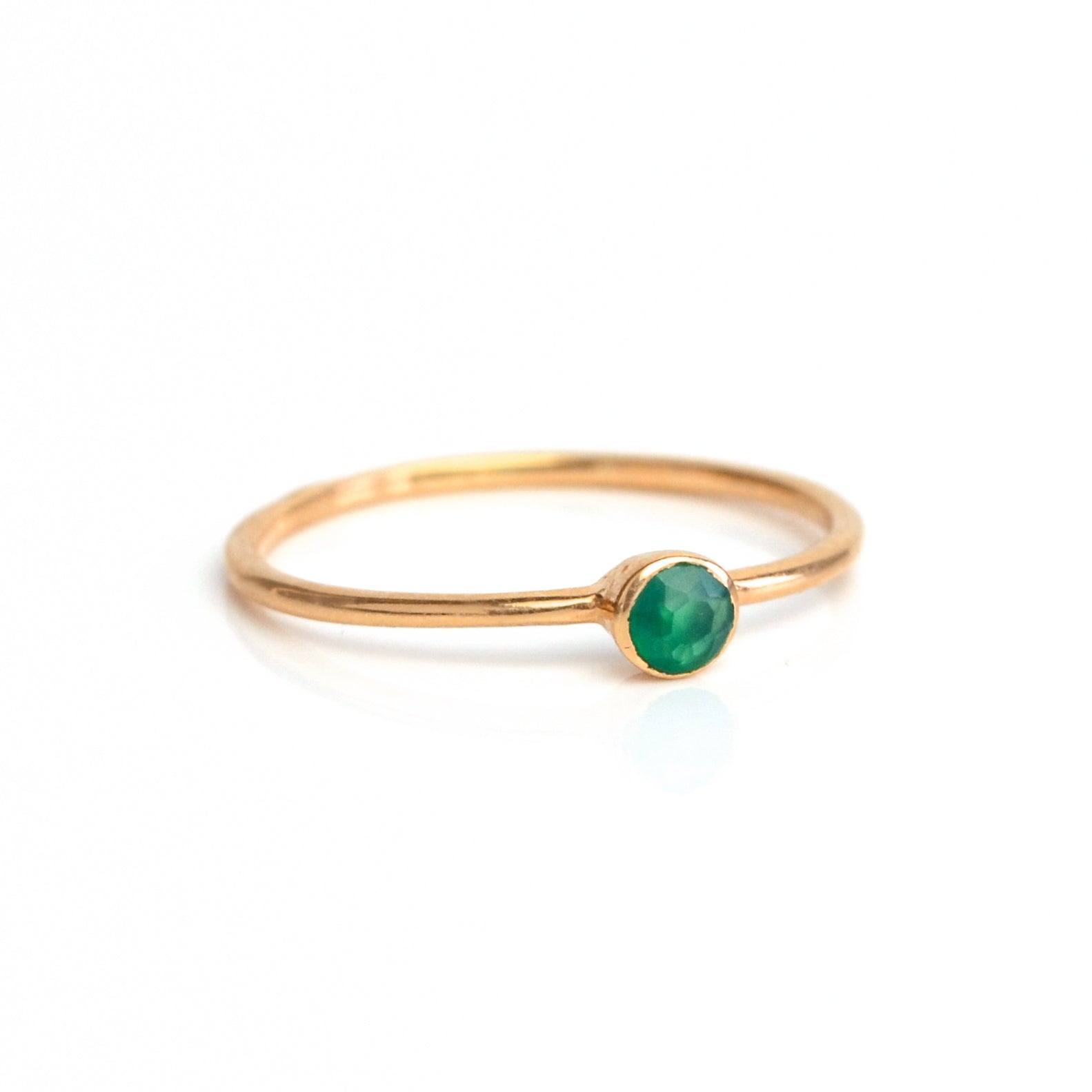 Single rose gold plated green onyx birthstone dainty gemstone ring on a white background. May birthstone.