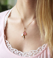 Model wearing gold filled cable style necklace with pink chalcedony and moonstone with tiny bar engraved with names.