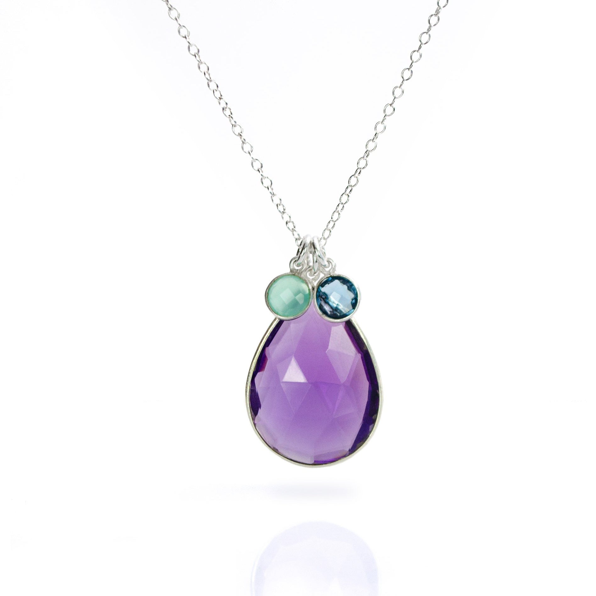 Single sterling silver large purple amethyst teardrop birthstone with two round aqua chalcedony and kyanite birthstones.