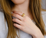 Mix and match these dainty 3mm birthstone bezel rings! Model is stylishly stacking moonstone sun burst and blue topaz and ruby tiny round rings.