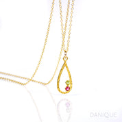 Single gold filled open teardrop frame pendant with peridot and ruby 3mm birthstones.