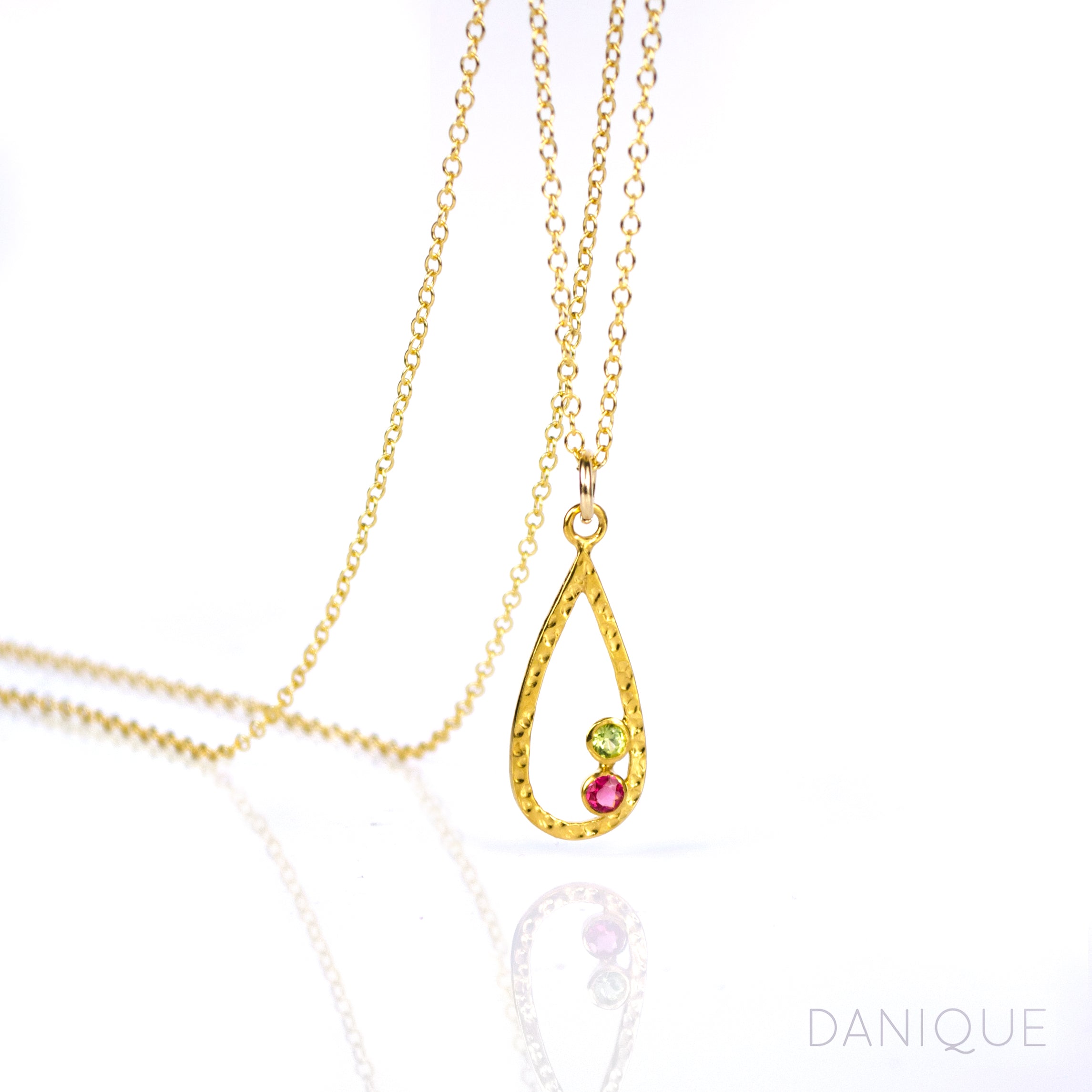 Single gold filled open teardrop frame pendant with peridot and ruby 3mm birthstones.