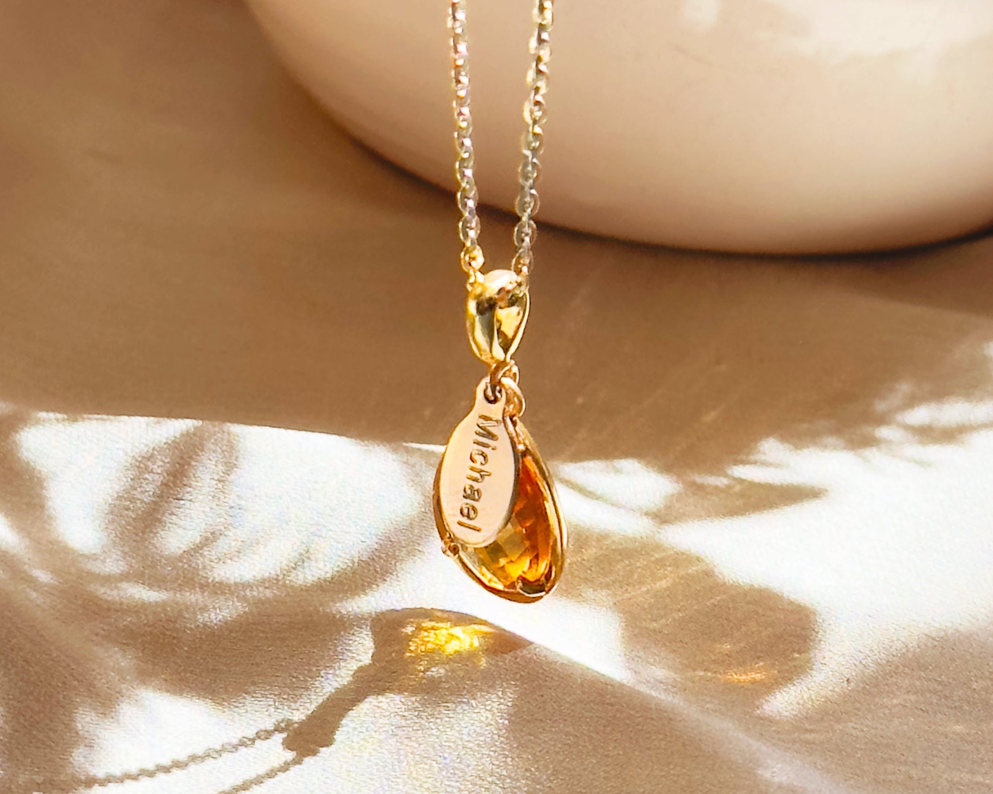 Golden citrine November birthstone necklace featuring a faceted teardrop gemstone in 18k gold vermeil with a hidden engraved name “Michael.” A warm, sunny keepsake symbolizing joy, abundance, and success.