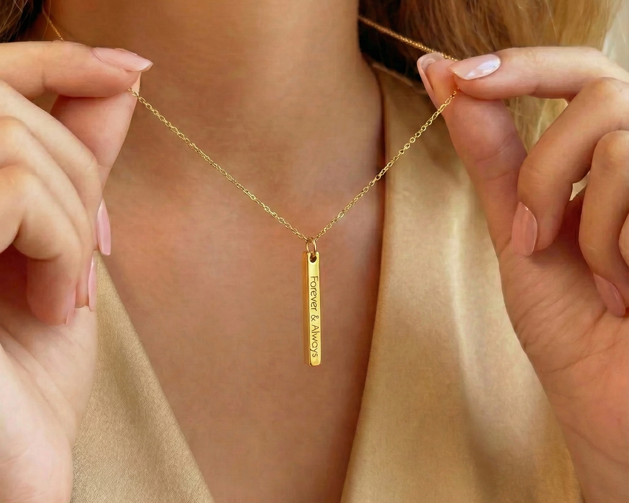 Dainty gold 3D bar necklace with vertical engraving worn on model holding chain, minimalist personalized bar pendant engraved “Forever & Always,” delicate custom name necklace jewelry gift for her.