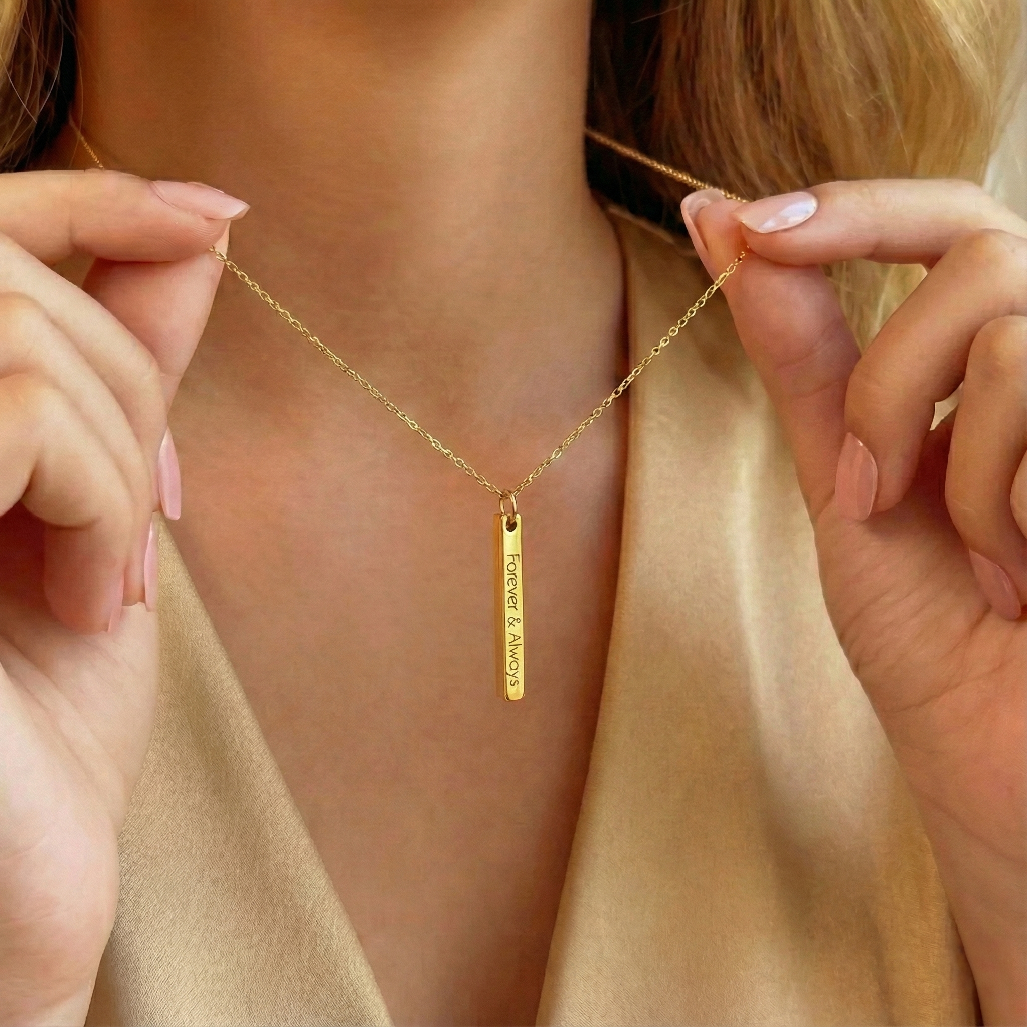 Dainty gold 3D bar necklace with vertical engraving worn on model holding chain, minimalist personalized bar pendant engraved “Forever & Always,” delicate custom name necklace jewelry gift for her.