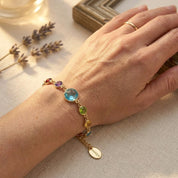 Mother wearing a custom birthstone bracelet while hugging her children, a sentimental jewelry gift for moms and grandmothers.