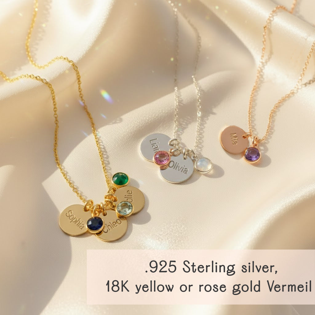 Flat lay of personalized birthstone disc charm necklaces in multiple finishes, showing engraved 13mm name discs and colorful 6mm birthstone charms. Ideal as family necklaces for moms or grandmas, bridesmaid gifts, birthdays, or layered minimalist jewelry. Each piece is custom engraved and features a dainty, feminine design perfect for everyday wear.