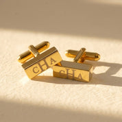 Personalized gold 3D bar cufflinks engraved with monogram initials in a modern rectangular design.
