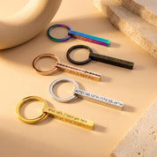 Sleek 3D bar keychains in silver, gold, rose gold, black, and rainbow finishes arranged on a white background, each engraved with custom names, dates, or short messages. Modern personalized keyring set shows scale, polish, and color options—ideal for groomsmen gifts, new-driver “drive safe” presents, and long-distance coordinates keychain ideas for him or her.