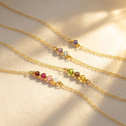 Minimalist bar mom necklace with faceted birthstones in gold, featuring a dainty horizontal gemstone bar representing children or family members, perfect personalized jewelry for Mother’s Day or everyday layering