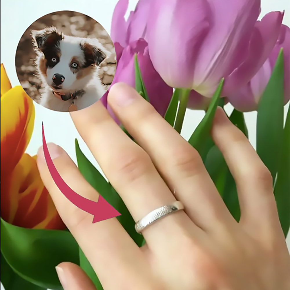 A hand wearing an engraved dog nose print ring. Dog nose print ring, engraved pet ring, custom dog jewelry, sterling silver dog ring, vermeil gold pet ring, rose gold dog ring, personalized pet ring, dog lover gift, pet keepsake jewelry, custom engraving, unique pet memorial, dog owner gift, pet jewelry