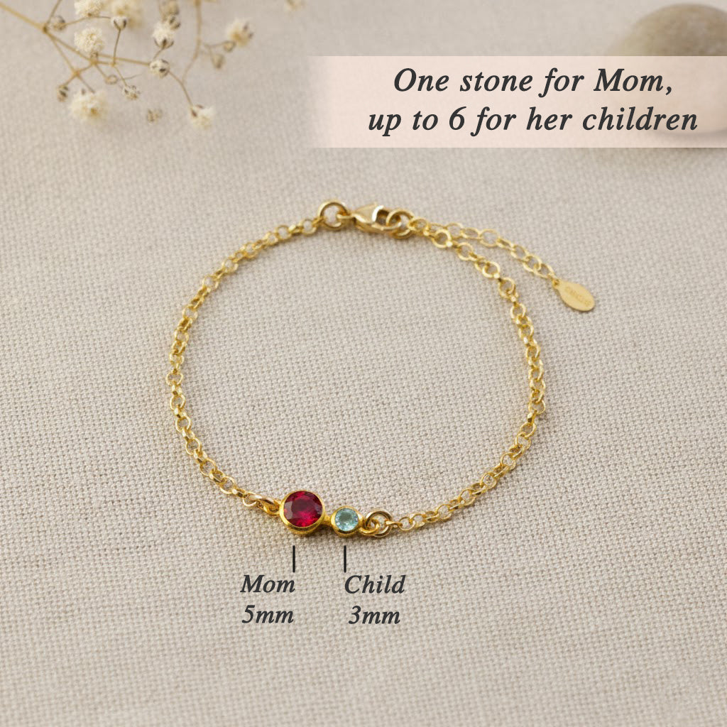 Our rose gold birthstone bracelet for mom highlights a 5mm gemstone representing her and up to six 3mm stones symbolizing her children, creating an elegant family jewelry keepsake full of meaning.