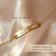 Close up of engraved name bar charm bracelet, precision custom engraving on minimalist gold bar jewelry