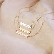 3 engraved bar necklaces with inspirational words lie on a pink velvet background. Custom heartbeat necklace engraved sonogram jewelry personalized baby heartbeat necklace for new mom postpartum gift. Custom minimalist bar name necklace Personalized engraved bar tag Minimalist bar pendant for personalization Custom engraved bar keepsake