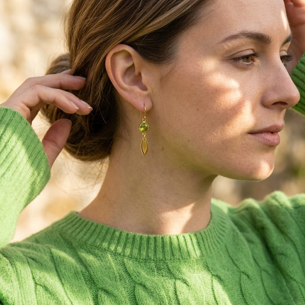 Model wearing green custom birthstone earrings with marquise tags, dainty personalized drop earrings