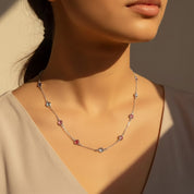 Custom birthstone necklace worn by model in sterling silver, featuring multiple tiny round bezel-set birthstones spaced along a delicate chain, personalized family necklace for mom or grandma, minimalist everyday jewelry gift with children’s birthstones, Valentines’s Day keepsake necklace