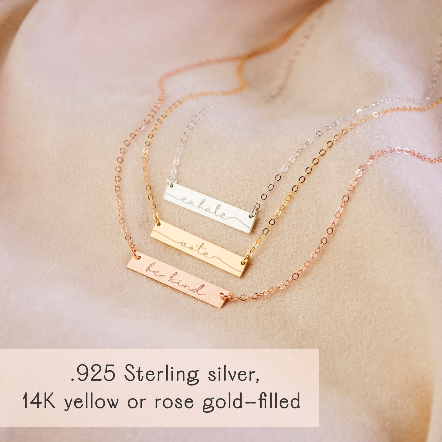 a silver, gold and rose gold necklace on a peach background. Personalized bar necklace for special events Custom bar pendant with initials Engraved bar necklace for her special occasion Personalized minimalist bar necklace with message Custom bar necklace for personalized moments Engraved bar pendant for holidays Personalized bar necklace for unique gifts Custom minimalist bar jewelry piece
