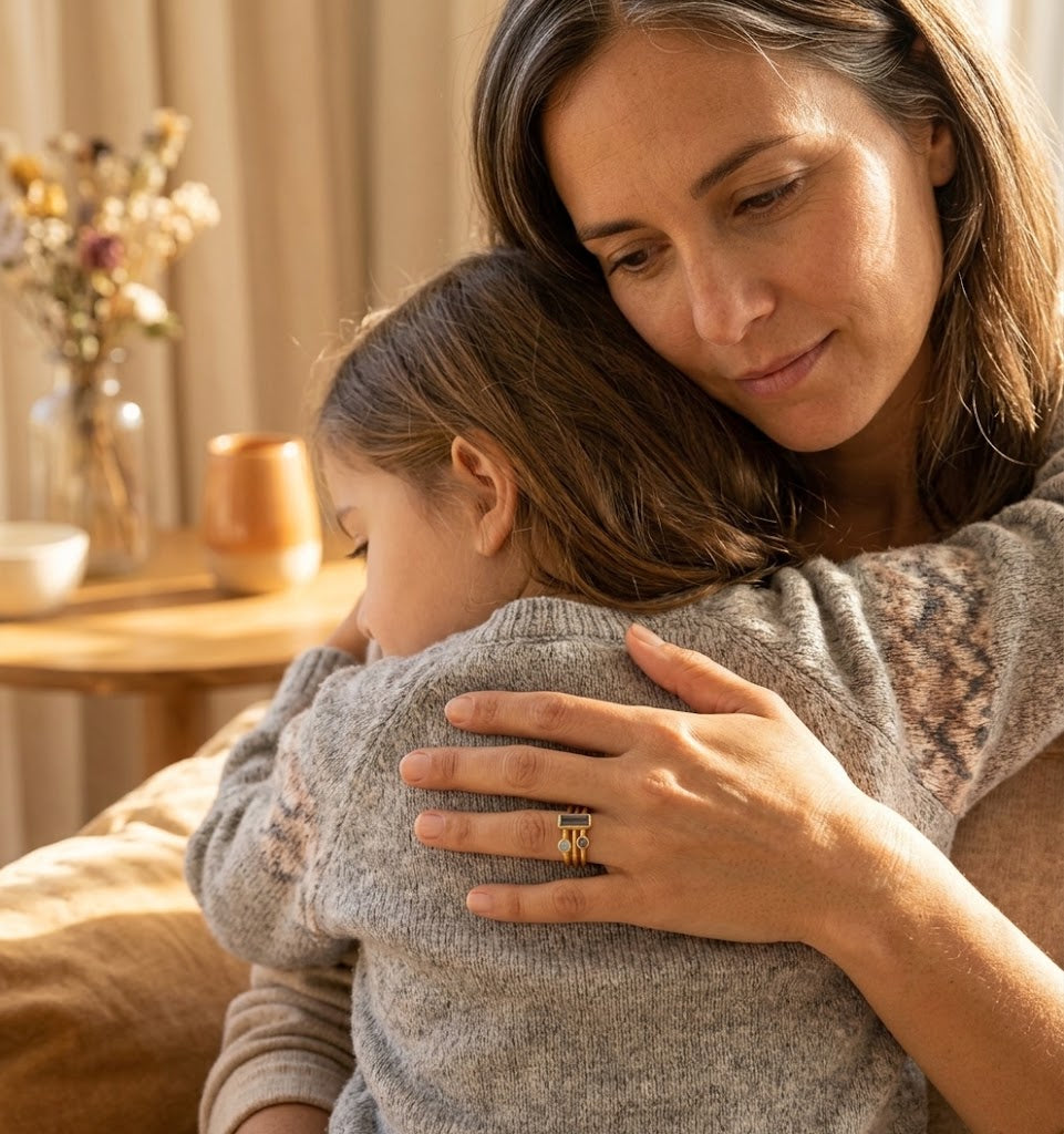 Mom wearing personalized family birthstone rings while holding child