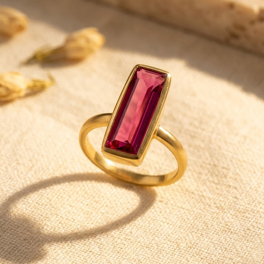 Ruby quartz baguette ring shown in gold with a rectangular July birthstone.