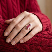 Ruby quartz Adira ring worn on a model’s hand with a burgundy sweater.