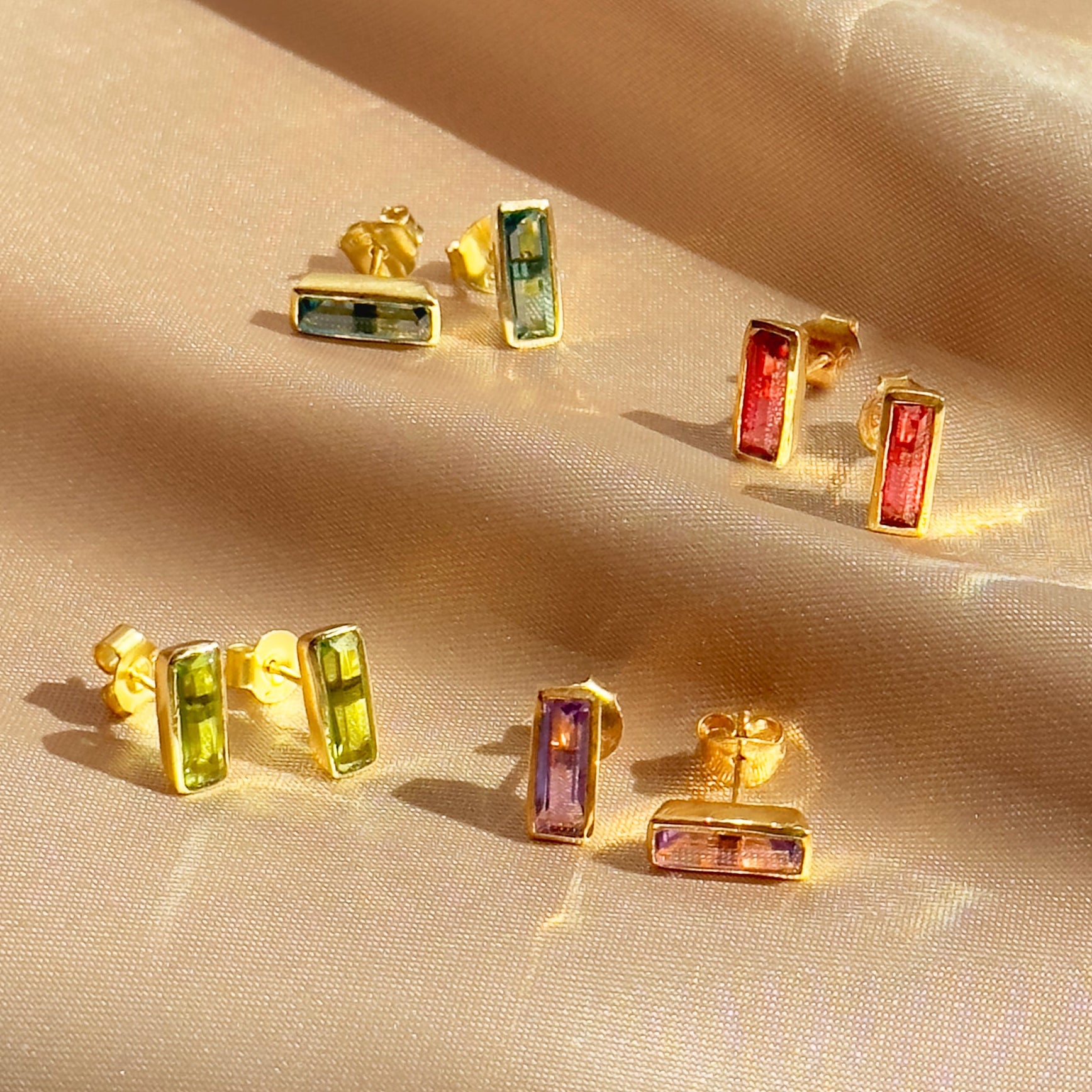 Set of colorful baguette-cut gemstone stud earrings including blue labradorite, garnet, amethyst, citrine, and peridot. Handmade jewelry by Danique Jewelry in 18K gold vermeil or sterling silver. Dainty minimalist earrings perfect for layering or mix-and-match birthstone sets. Personalized jewelry gift for her, bridesmaid, or birthday, with bright natural stones in modern rectangular bar design.