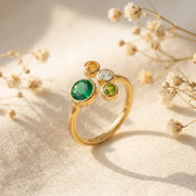 Adjustable gold mother’s birthstone ring with one 5 mm gemstone and three petite 3 mm children’s stones.

