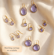 Matching alexandrite earrings and necklace pieces in soft purple gemstone styles.