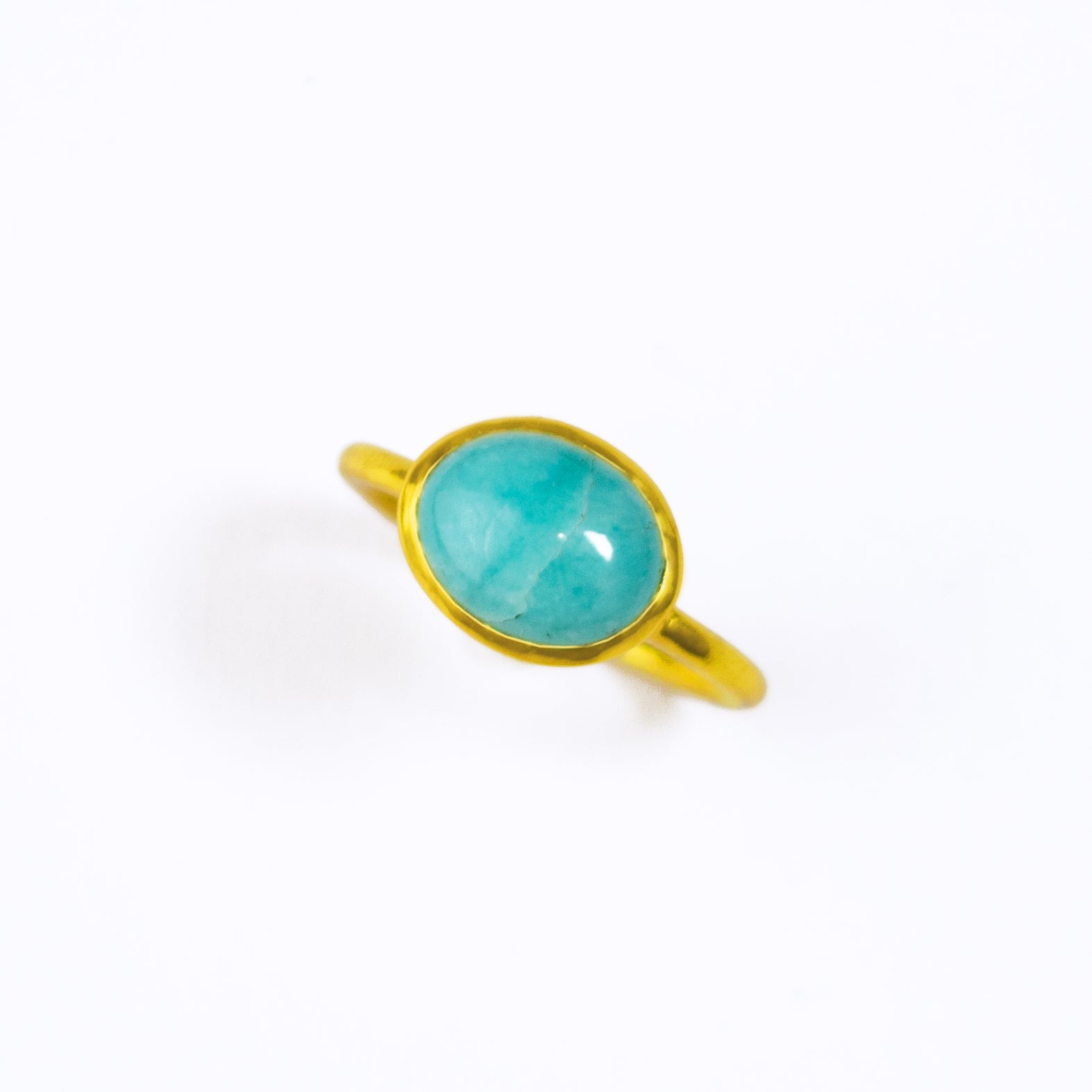 A beautiful vermeil gold teal blue amazonite cabochon ring rests against a white background. Vermeil Gold Large Oval Ring Bezel Set with a turquoise blue amazonite cabochon stone on a white background. Teal Ring, Delicate Gold Ring, Stacking Amazonite Ring, Healing Gemstone Ring