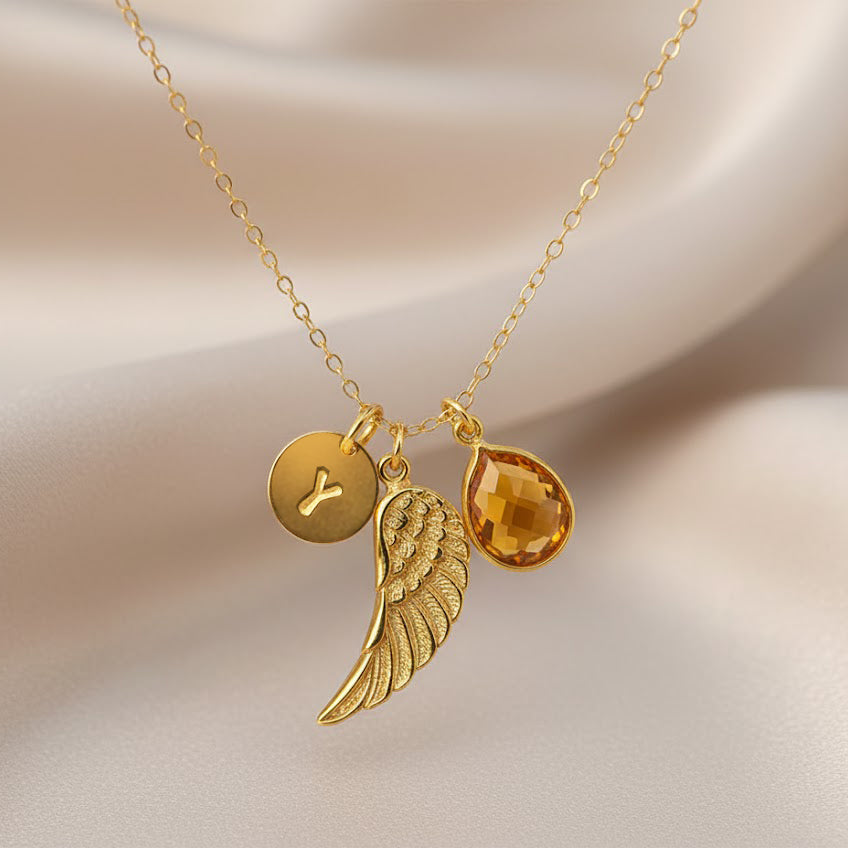 Gold angel wing memorial necklace with engraved initial disc and teardrop birthstone charm, personalized remembrance jewelry sympathy gift for loss.