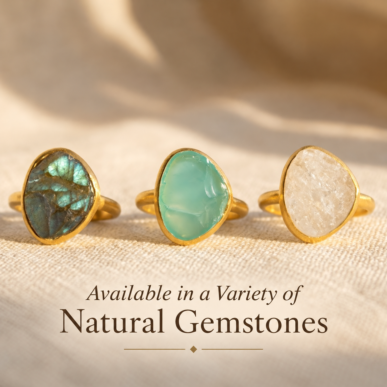 Large rough cut aqua chalcedony, labradorite and moonstone teardrop rings in yellow gold vermeil displayed in natural light.