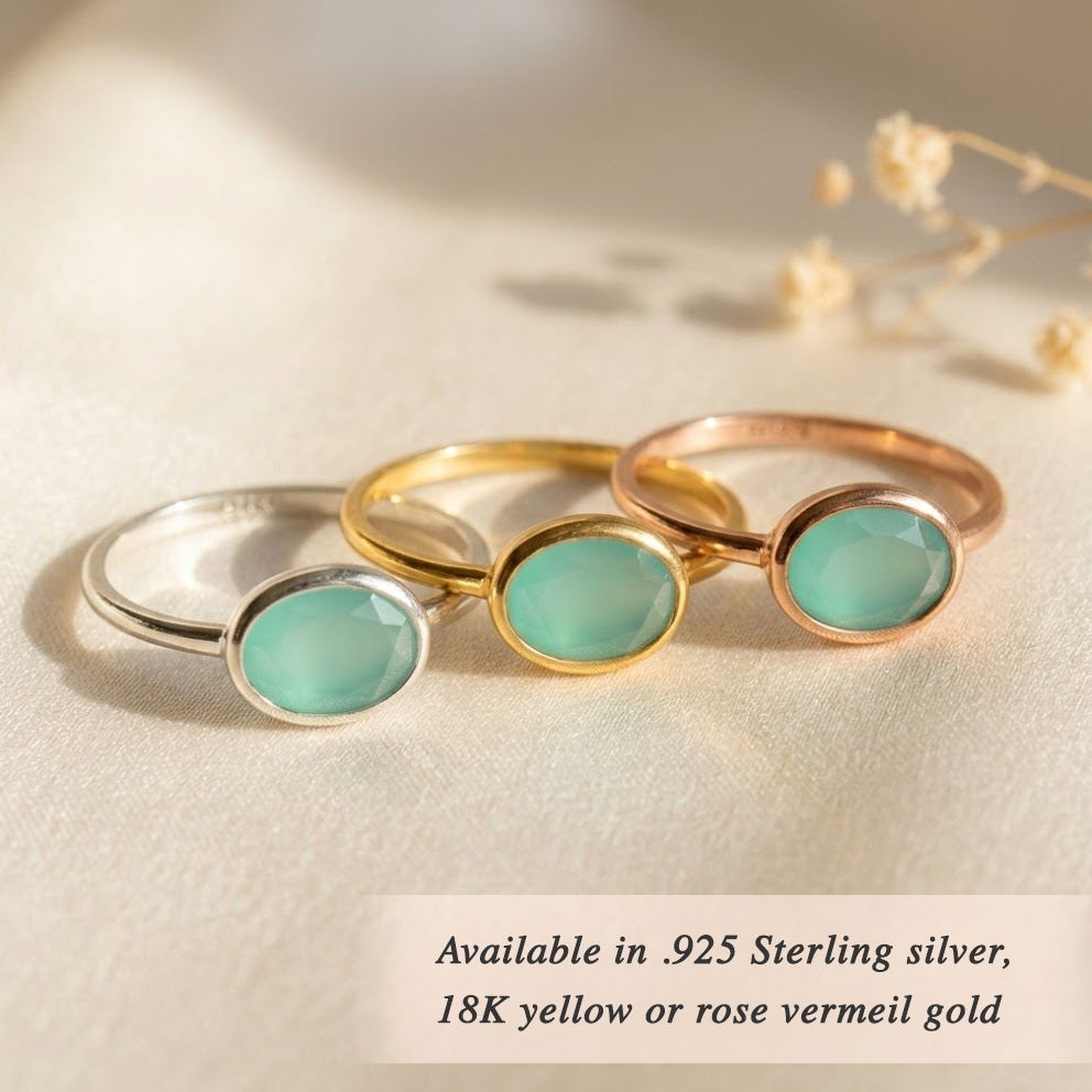 Dainty gold aquamarine ring stacked with other birthstone rings