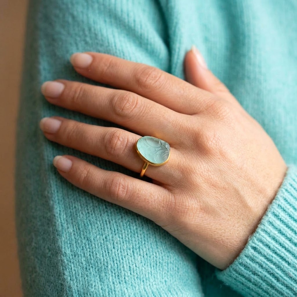 Woman wearing a large aqua chalcedony teardrop ring in yellow gold vermeil.

