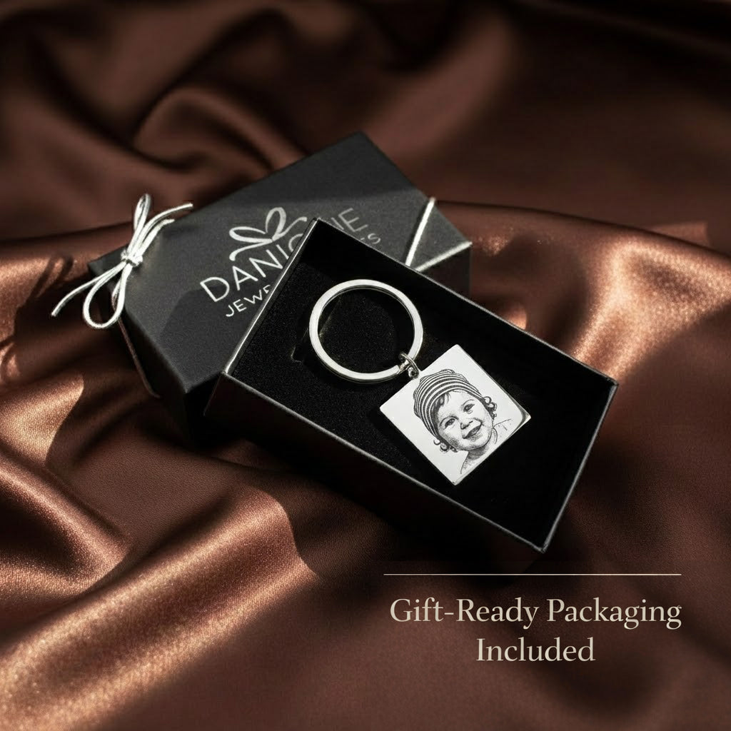 Custom baby photo keychain presented in premium gift-ready packaging, displayed in a Danique Jewelry box. This personalized engraved baby picture keychain is crafted from stainless steel and arrives ready for gifting, making it an ideal keepsake gift for new moms, baby showers, Mother’s Day, or meaningful memorial jewelry.