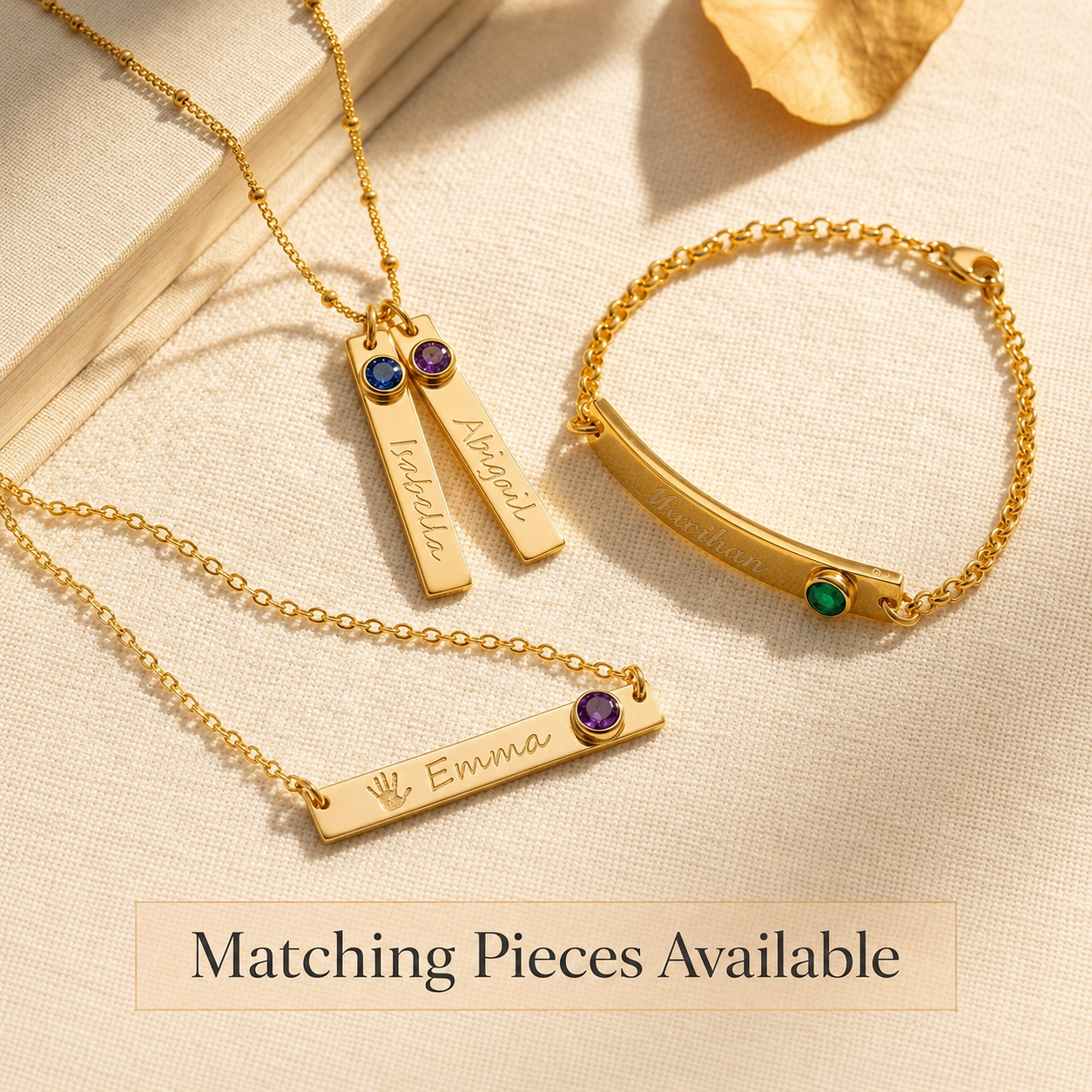 Matching personalized birthstone jewelry pieces including bar necklace, bracelet, and vertical bar necklace.