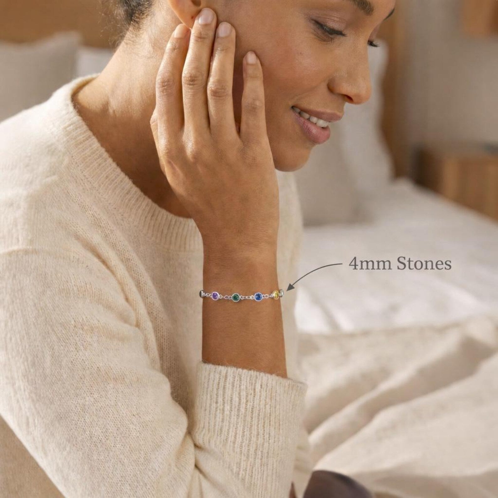 Woman wearing a custom birthstone bracelet featuring larger 4mm bezel-set gemstones on a delicate chain. Personalized family bracelet designed with children’s birthstones, handcrafted in sterling silver or gold vermeil. Elegant everyday jewelry gift for mom or grandma, combining minimalist style with meaningful personalization.